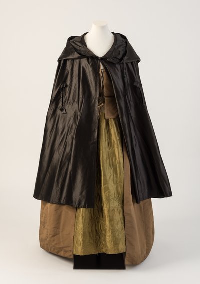 Black silk satin cape, worn with olive green silk quilted petticoat, 1760s by Unbekannt Unbekannt